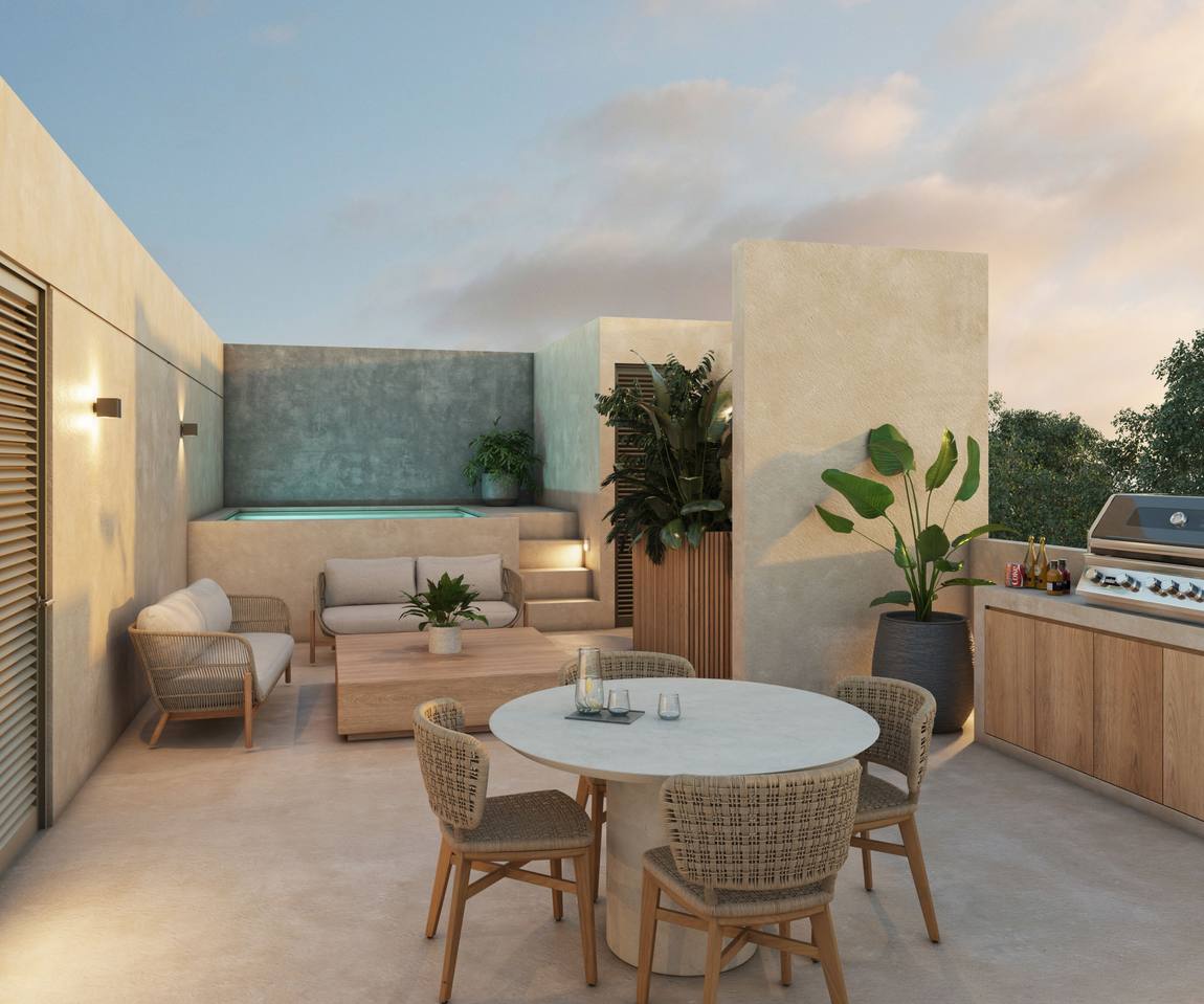 Roof top con piscina, asador y comedor exterior al atardecer.
